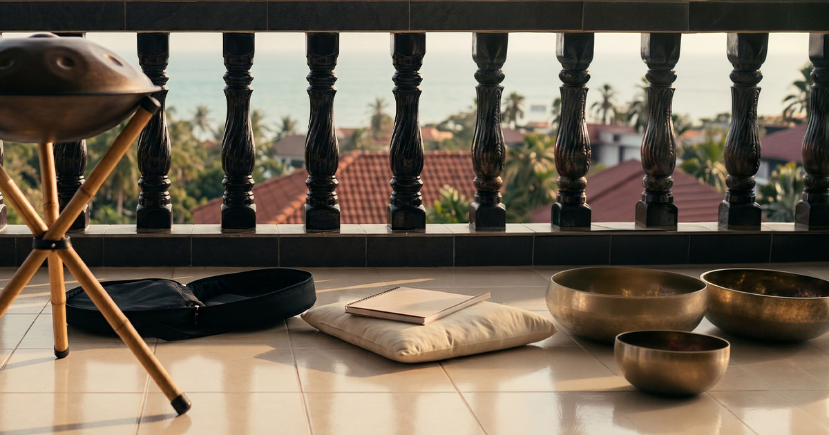 A handpan on a stand next to its soft bag on a terrace in Koh Samui