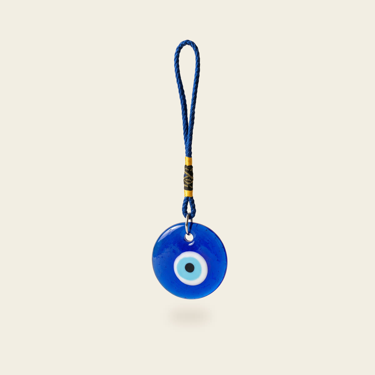 Blue glass evil eye charm on a braided blue cord