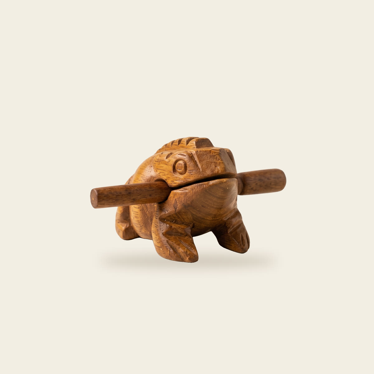 Carved wooden frog guiro with its stick
