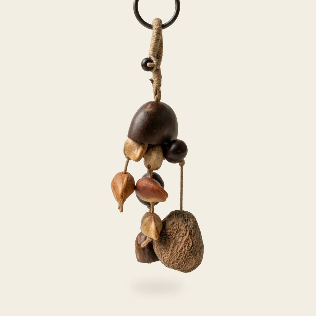 Small shaker of mixed dried seeds and shells on a cord